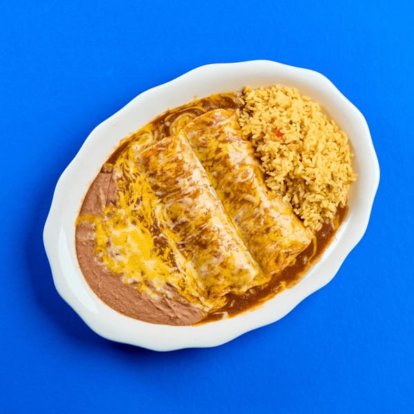 Two cheesy enchiladas with brown sauce, refried beans, and yellow rice on a white plate.