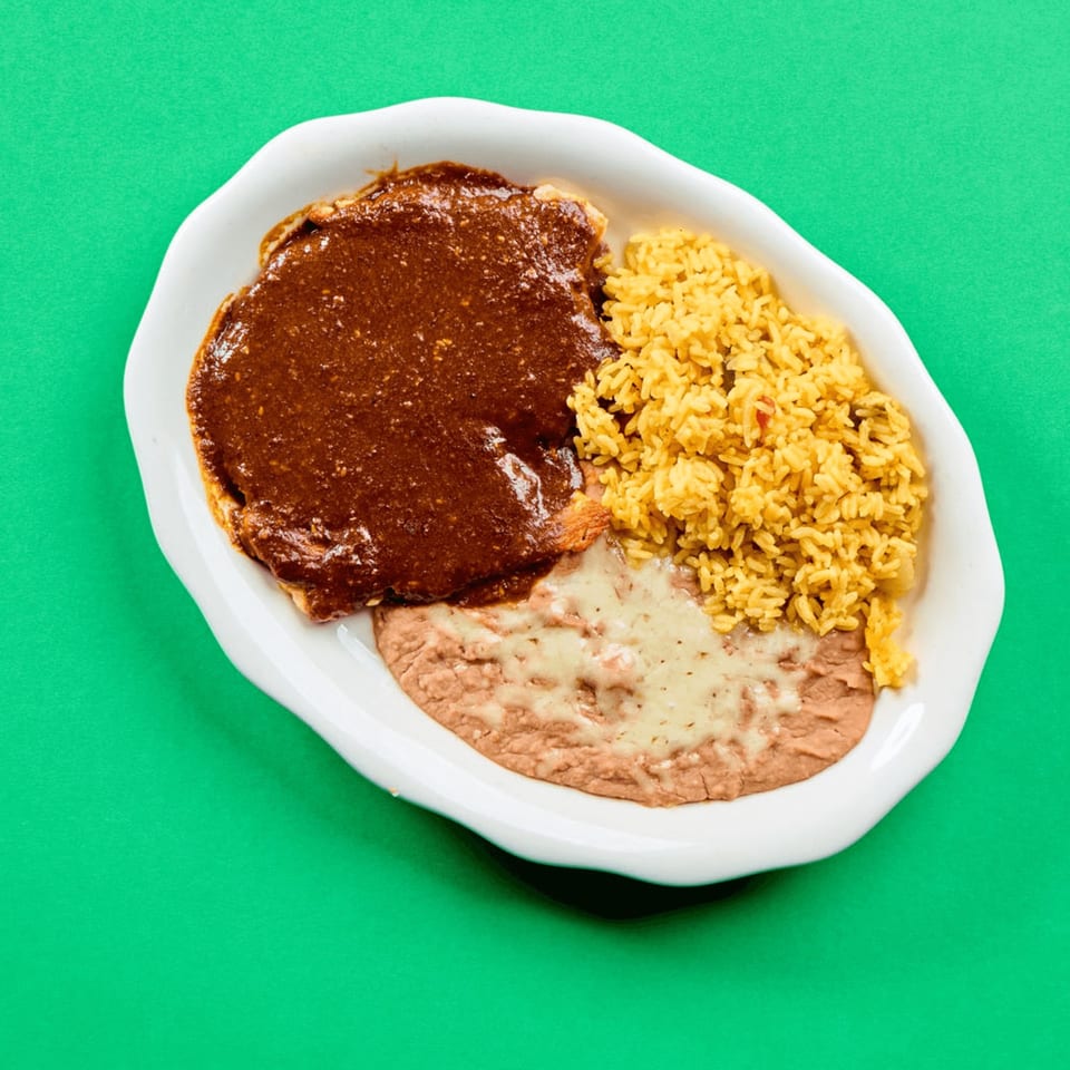 La Bamba's Mexican dish with chicken mole, yellow rice, and refried beans with melted cheese.