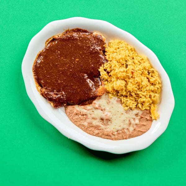 La Bamba's Mexican dish with chicken mole, yellow rice, and refried beans with melted cheese.