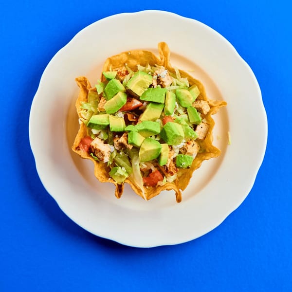 La Bamba's taco salad with chicken, avocado, lettuce, and tomatoes in a crispy tortilla bowl.